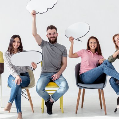 Group of young people sitting with idea bubbles in their hands. Langly logo in the corner.
