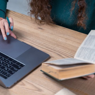 Learning with a book and laptop